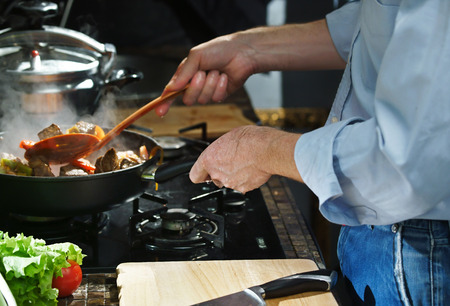 Chef prepares hotpot in the stew pan in the kitchenの写真素材