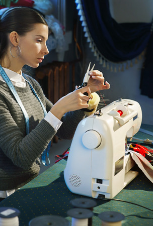 Couturier working at a sewing machineの写真素材