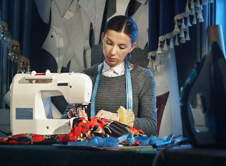 Seamstress working at a sewing machineの写真素材