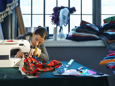Seamstress working at a sewing machineの写真素材