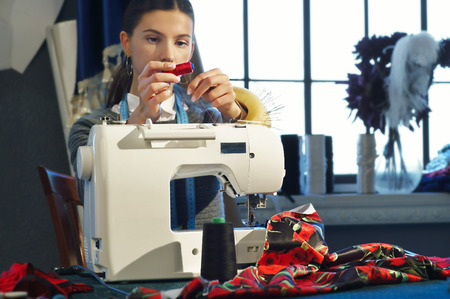 Seamstress working at a sewing machineの写真素材