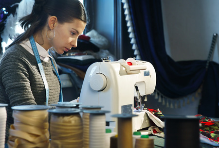 Seamstress working at a sewing machineの写真素材