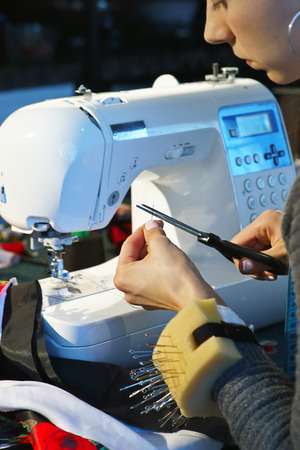 Seamstress working at a sewing machineの写真素材