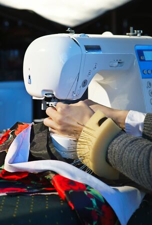 Seamstress working at a sewing machineの写真素材