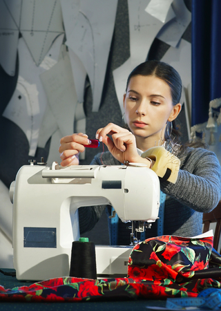 Seamstress working at a sewing machineの写真素材