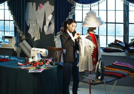 Couturier sews a dress in the studioの写真素材