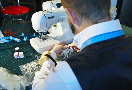 Couturier sews a dress on the sewing machineの写真素材