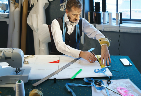 Designer designs dress patterns on paperの写真素材