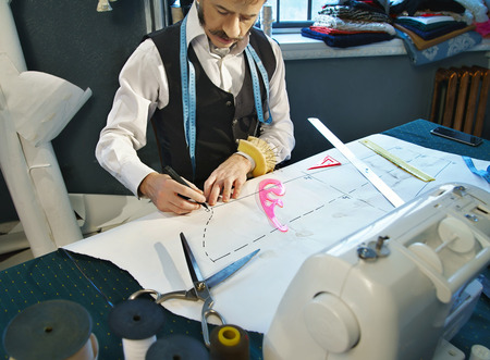 Designer designs dress patterns on paperの写真素材