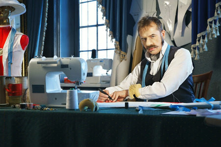 Designer designs dress patterns on paper の写真素材