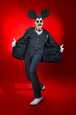 Man in a hat of a mouse on the red backgroundの写真素材