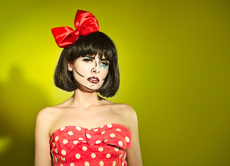 Portrait of funny mime girl with a red bow in a polka-dot dressの写真素材