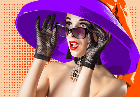 Portrait of a surprised girl with a hat and sunglasses in a pop art styleの写真素材