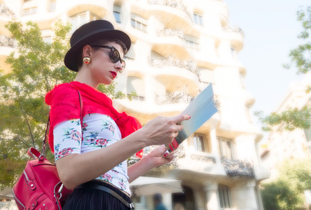 Tourism in Europe, woman tourist with map on the streetの写真素材