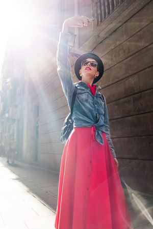 Tourism in Europe, Girl taking selfie self-portrait on smartphone on the streetの写真素材