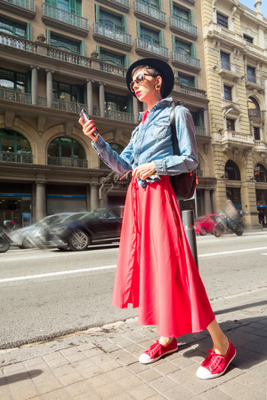 Tourism in Europe, woman tourist with smartphone on the street of Barcelonaの写真素材