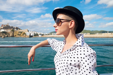 Woman on yacht enjoying sea walk along coastの写真素材