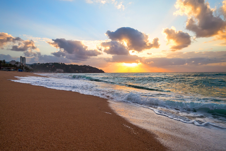 Beautiful sunrise over sea and cityの写真素材
