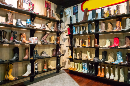 Stylish cowboys boots on a shelf in a storeの写真素材