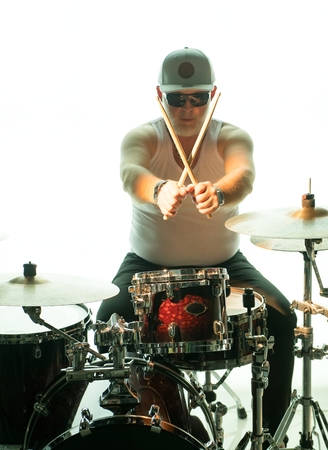 Man plays musical percussion instrument with drumsticksの写真素材