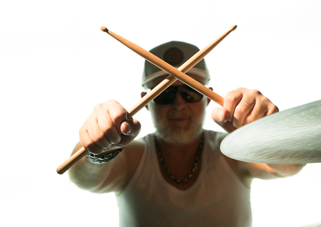 Man plays musical percussion instrument with drumsticksの写真素材
