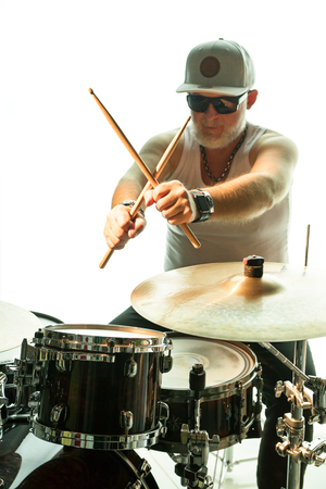 Man plays musical percussion instrument with drumsticksの写真素材