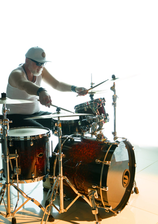 Drummer with fingers bandaged playing drumsの写真素材