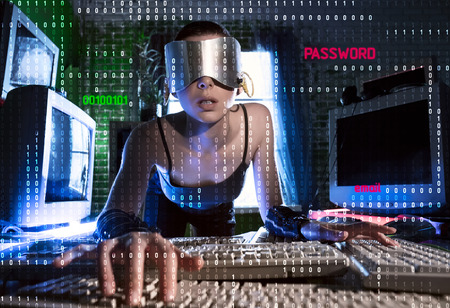 Masked hacker working on a code with digital interface aroundの写真素材