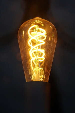 Old edison light bulb with glowing spiral