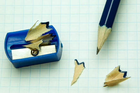 blue pencil and a blue pencil sharpener on a sheet of paper in the cageの写真素材