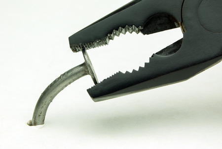 curve of the nail and pliers on a white backgroundの写真素材