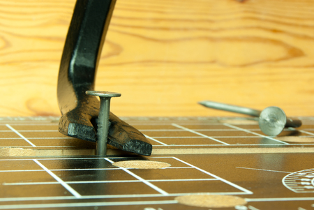 crowbar and one nail on the workbench, tableの写真素材