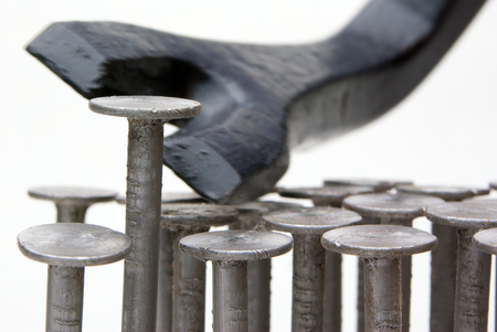 crowbar and high nail, several nails on a white backgroundの写真素材