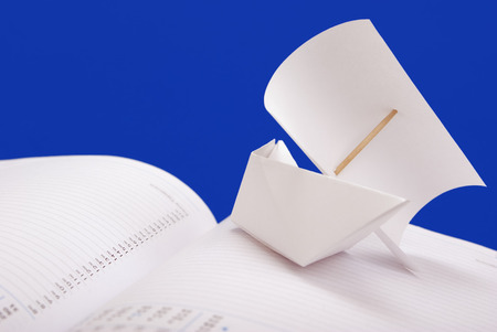 White paper ship with a sail the notebook the scheduleの写真素材