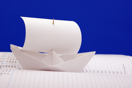 White paper ship with a sail the notebook the scheduleの写真素材