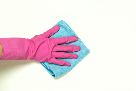 One hand in pink rubber gloves with blue cloth on a white background