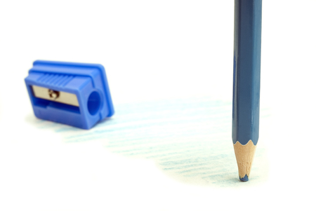 blunt blue pencil with a blue sharpener on a white backgroundの写真素材