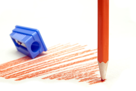 dull red pencil blue pencil sharpener on a white backgroundの写真素材