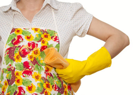female torso in white shirt apron hand with yellow glove holding orange cloth on a white backgroundの写真素材