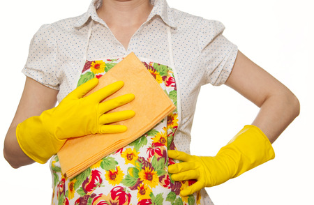 female torso in white shirt apron hand with yellow glove holding orange cloth on a white backgroundの写真素材