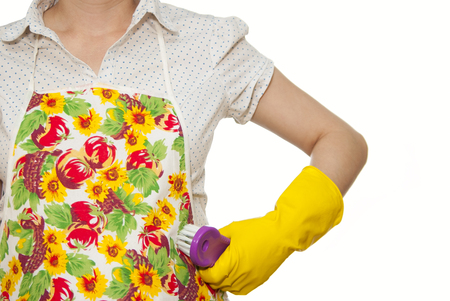 female torso in white shirt apron hand with yellow glove holding a purple brush on a white backgroundの写真素材