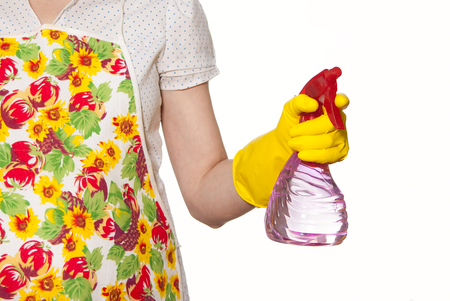 female torso in white shirt apron hand with yellow glove holding a red spray bottle on a white backgroundの写真素材