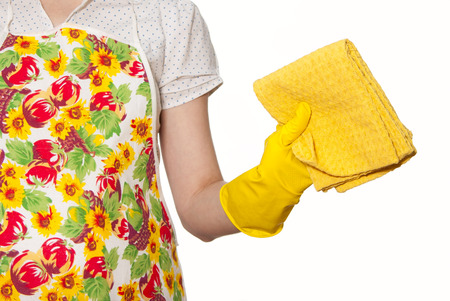 female torso in shirt and apron hands in yellow gloves with yellow cloth in hand on a white backgroundの写真素材