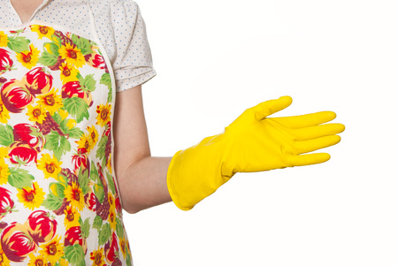 female torso wearing a white shirt in the color apron hand in yellow glove on a white backgroundの写真素材