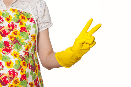 female torso wearing a white shirt in the color apron, hand in glove yellow sign with two fingers on a white backgroundの写真素材