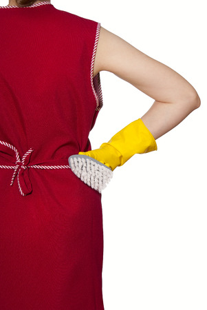 female torso in a red smock hand in yellow glove with gray brush on a white backgroundの写真素材