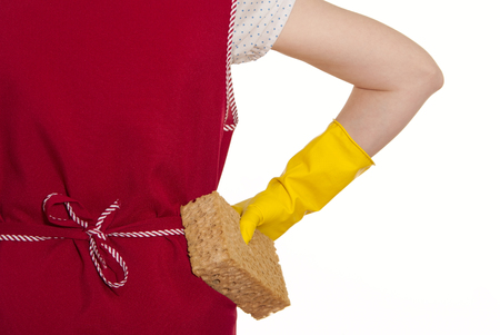 female torso in a red smock hand in yellow glove with sponge on a white backgroundの写真素材