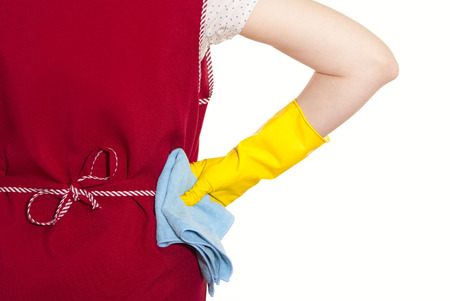 female torso in a red smock hand in yellow glove with blue cloth on a white backgroundの写真素材