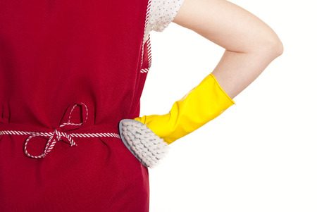 female torso in a red smock hand in yellow glove with gray brush on a white backgroundの写真素材