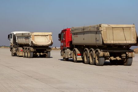 TULCEA, ROMANIA - NOVEMBER 08: Trucks transporting bitumen on a runway as part of the Danube Delta international airport expansion plan on November 08, 2015 in Tulcea, Romania.のeditorial素材